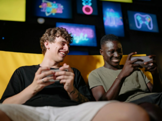 A Low Angle Shot of Men Sitting on the Couch while Holding their Mobile Phones