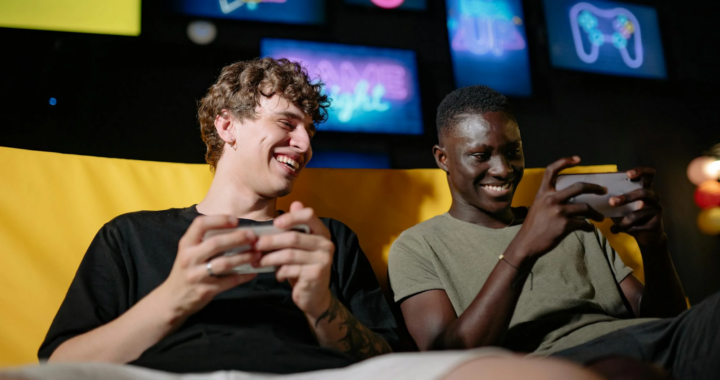 A Low Angle Shot of Men Sitting on the Couch while Holding their Mobile Phones